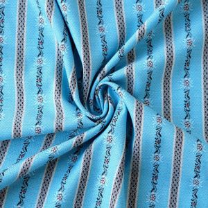 Nahaufnahme des gewobenen Edelweiss Baumwollstoffes in türkis, mit sichtbarer Garnstruktur und dem feinen Edelweiss-Muster in Streifen.