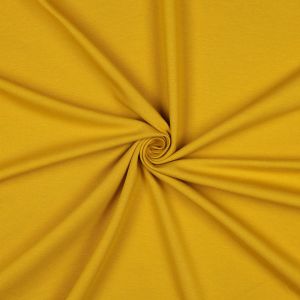 Ocker GOTS French Terry Bio-Stoff, weich, bielastisch. Nahaufnahme der glatten, mittelschweren Baumwoll-Oberfläche. 