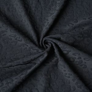 Bielastischer Shape-Lycra mit eingestricktem Leo-Design in Schwarz: Detail der dreidimensionalen Struktur und des stützenden Materials bei spitzentraum.